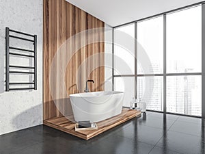 Corner view of wood bathtub area in grey and white bathroom space