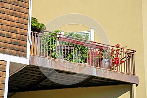 Corner wedge shapped balcony and patio in the neighborhood or in a suburban setting on the side of house