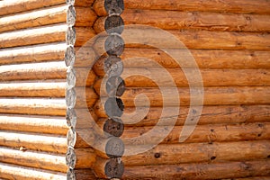 Corner of wooden wall log house. Old traditions of construction.