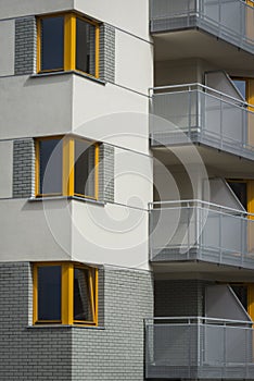 Corner yellow wooden windows in multi family house