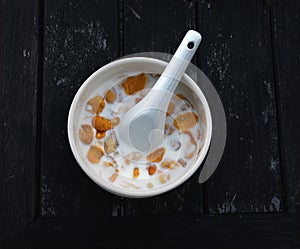 Cornflake with white bowl on the wood table