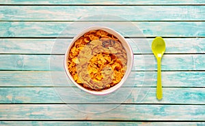 Cornflakes bawl on a vintage wooden table. Spoon. Organic Food photo