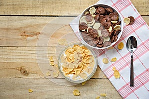 Cornflakes breakfast and various cereals bowl milk cup on wooden table background for cereal healthy food
