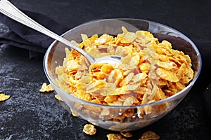 Cornflakes cereal and milk in a glass bowl. Morning breakfast co