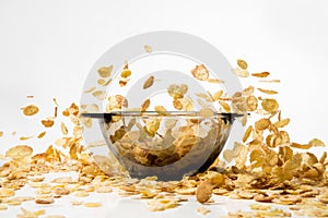 Cornflakes falling into a pile, over white background