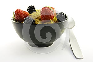 Cornflakes and Fruit in a Black Bowl with a Spoon