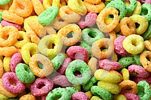 Cornflakes rings breakfast cereal with fruits on a white background Close to yellow, green and red colors Baby food is served with