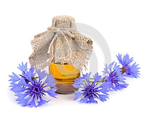 Cornflower with pharmaceutical bottle.