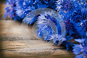 Cornflowers over wood photo