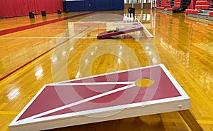 Cornhole game boards and bowling set up in a gym