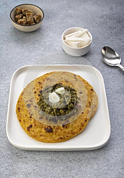 Cornmeal breads and  mustard leaves curry, famous Indian food specially prepared in winters, makki ki roti - sarson ka saag