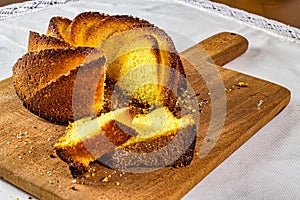Cornmeal cake. Typical Brazilian cornmeal cake with slices on wooden cutting board