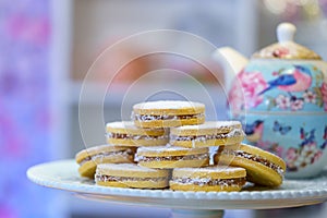 Cornstarch cookies with manjar and powdered sugar served on the white plate photo