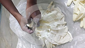 Cornstarch powder is being mixed with surgical gloves to reduce friction