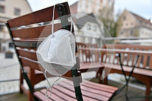 Corona crisis - lockdown - FFP2 mask hangs on a chair in an empty beer garden in Steyr, Austria, Europe photo