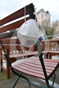 Corona crisis - lockdown - FFP2 mask hangs on a chair in an empty beer garden in Steyr, Austria, Europe photo