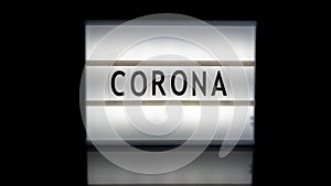 Corona letters on a light box on reflective surface