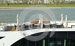 Corona lockdown for rivercruises, deck of cruiseship with empty chairs and interfolded sunshades