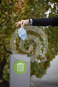 Corona mask getting thrown away into the trashcan