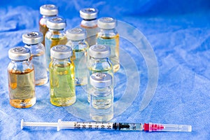 Corona virus and Covid - 19 new vaccine in ampules, different color variations of vaccine