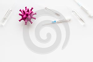 Corona virus Covid-19 - vaccine concept with syringe - on white background top-down frame copy space