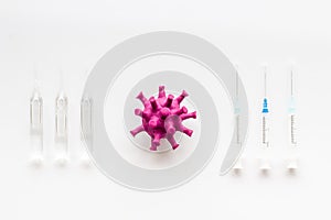 Corona virus Covid-19 - vaccine concept with syringe - on white background top-down pattern