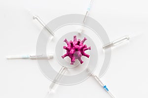 Corona virus Covid-19 - vaccine concept with syringe - on white background top-down pattern
