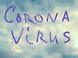 CORONA virus text on blue sky with white clouds.