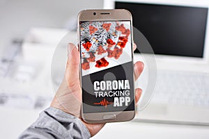 Corona Virus Tracking App concept with hand holding cell phone with application design on screen photo