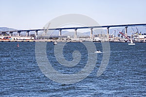 The Coronado Island to San Diego Bridge and the Shipyards Underneath with Boats on the San Diego Bay photo