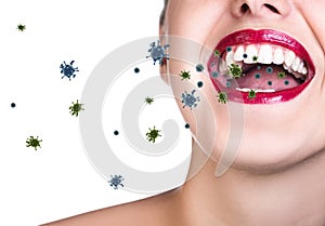 Coronavirus cells fly out from oprn mouth of young woman.