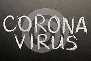 Coronavirus, chalk inscription on a black chalkboard. Pandemic, epidemic, global threat