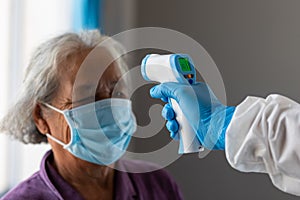 The coronavirus check post, Doctors checking temperature the aging female patient that is at risk for infection corona virus [