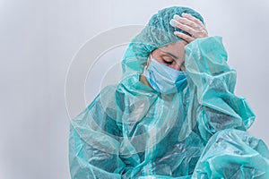 Coronavirus concept. COVID-19. Young female doctor in protective suit uniform, face mask and rubber gloves, before patient examina