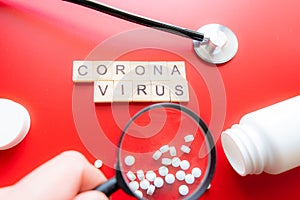 Coronavirus COVID-19 concept image wit text seen through a magnifying glass. Red Background