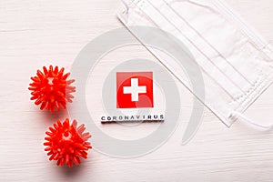 Coronavirus covid-19 concept. Top view protective breathing mask and flag of Switzerland.