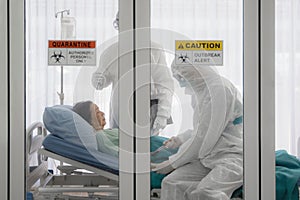 Coronavirus covid-19 infected patient on bed in quarantine room with quarantine and outbreak alert sign at hospital with disease