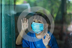 Coronavirus Covid-19 pm2.5. Cute asian young boy with blue shirt, wearing medical mask