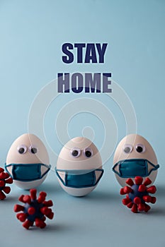 Coronavirus, COVID-19, self-quarantine, isolation, social disdancing concept. Stay home, stay safe message. Eggs wearing mask