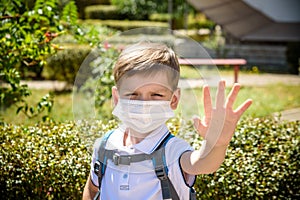 Coronavirus Covid-19.Stay home.Little boy wearing fabric mask show stop hands for stop coronavirus