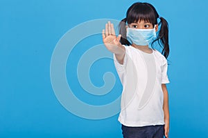 Coronavirus Covid-19.Stay at home Stay safe concept.Little girl wearing mask for protect.show stop hands gesture