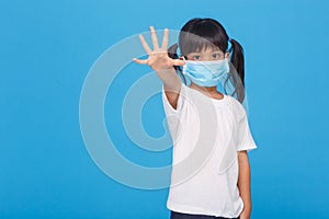 Coronavirus Covid-19.Stay at home Stay safe concept.Little girl wearing mask for protect.show stop hands gesture