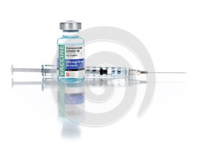 Coronavirus COVID-19 Vaccine Vial and Syringe On Reflective White Background