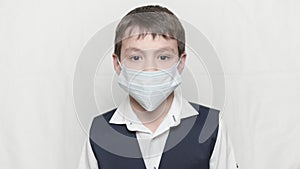 Coronavirus covid-19 epidemy outbreak healthcare concept of little boy in medical mask and school uniform photo