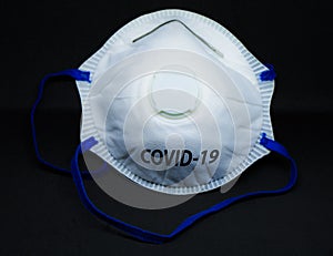 Face mask Coronavirus Covid-19 protective white maskblack background air filter photo