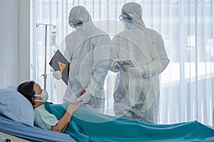 Coronavirus covid 19 treatment background of coronavirus covid 19 patient on bed with doctors in PPE coverall suit in hospital photo