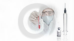 Coronavirus covid-19 vaccine reseach background of scientist in coverall suit with syringe and bottle of coronavirus covid-19 photo