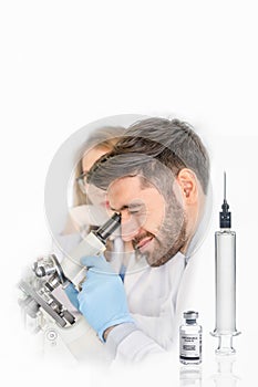 Coronavirus covid-19 vaccine reseach background of scientist using microscope in labolatory with syringe and bottle of coronavirus photo