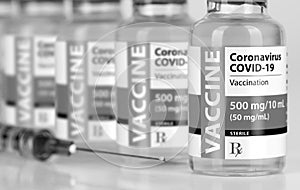 Coronavirus COVID-19 Vaccine Vials and Syringe On Reflective Surface