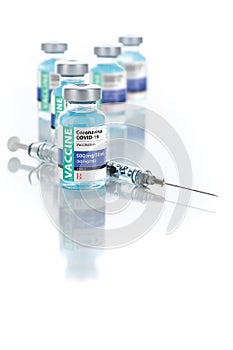 Coronavirus COVID-19 Vaccine Vials and Syringe On Reflective Surface